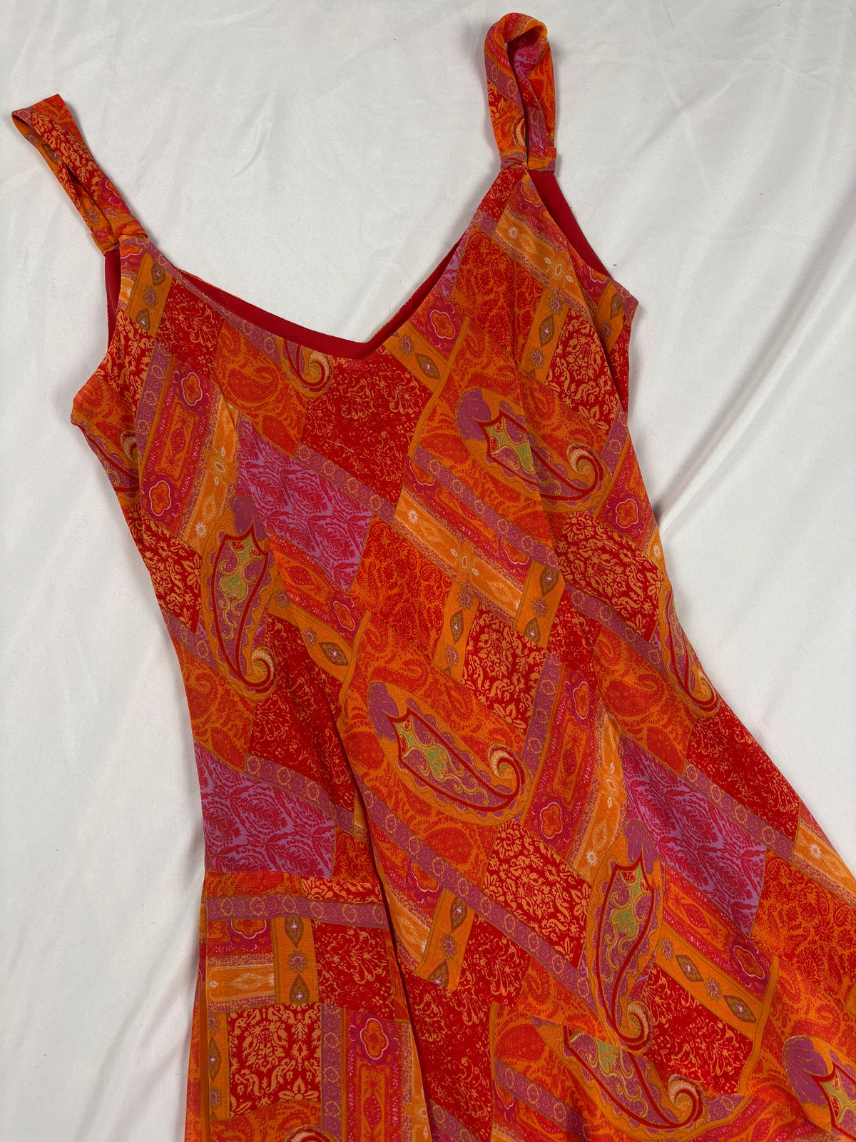 Orange paisley patchwork style midi dress with asymmetric hem