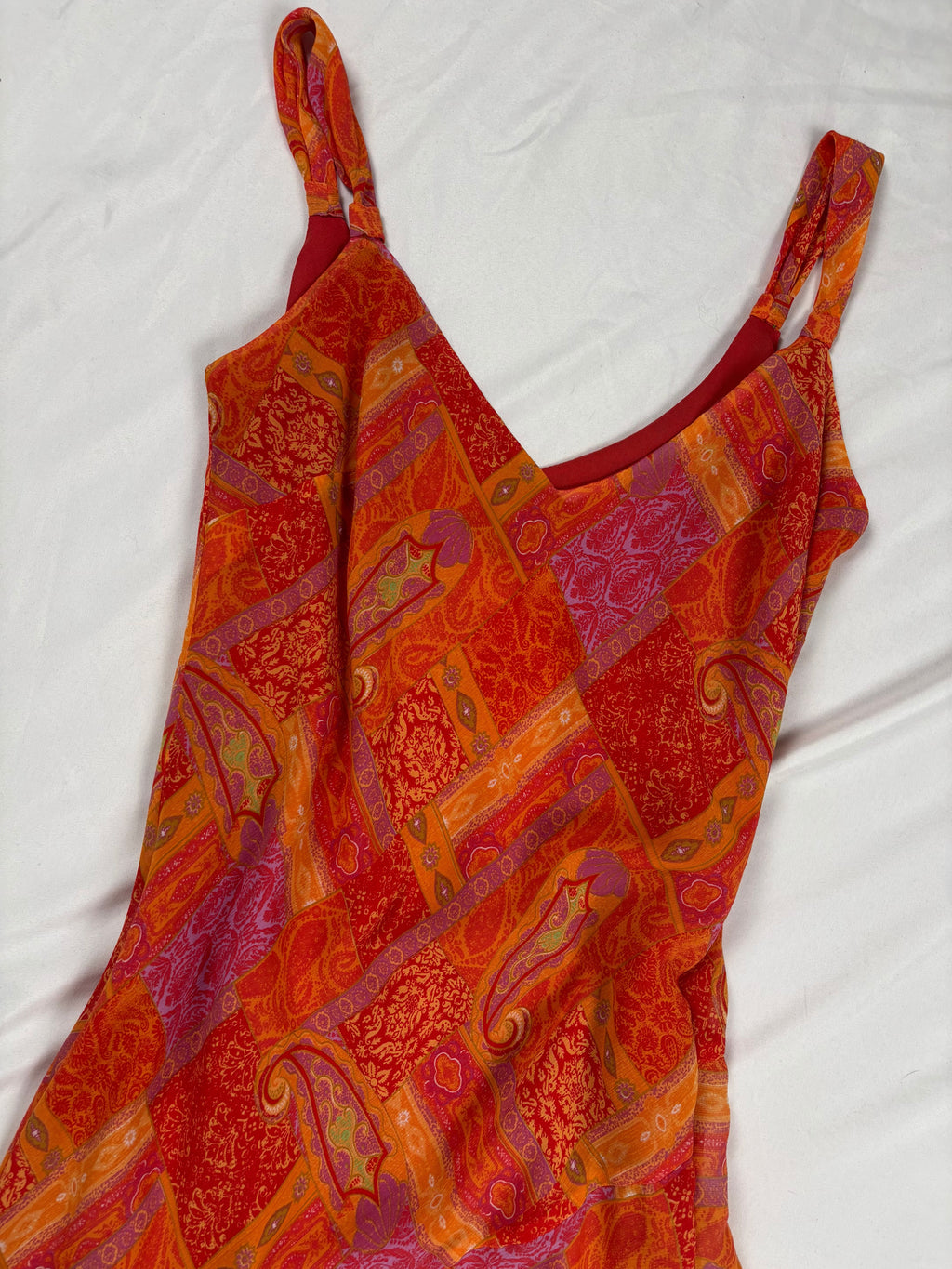 Orange paisley patchwork style midi dress with asymmetric hem