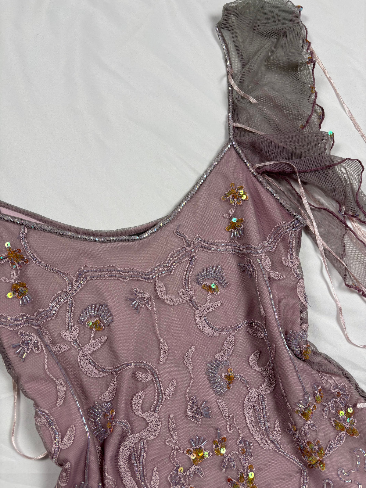 Muted purple ruffle sleeve top with embroidered sequin details
