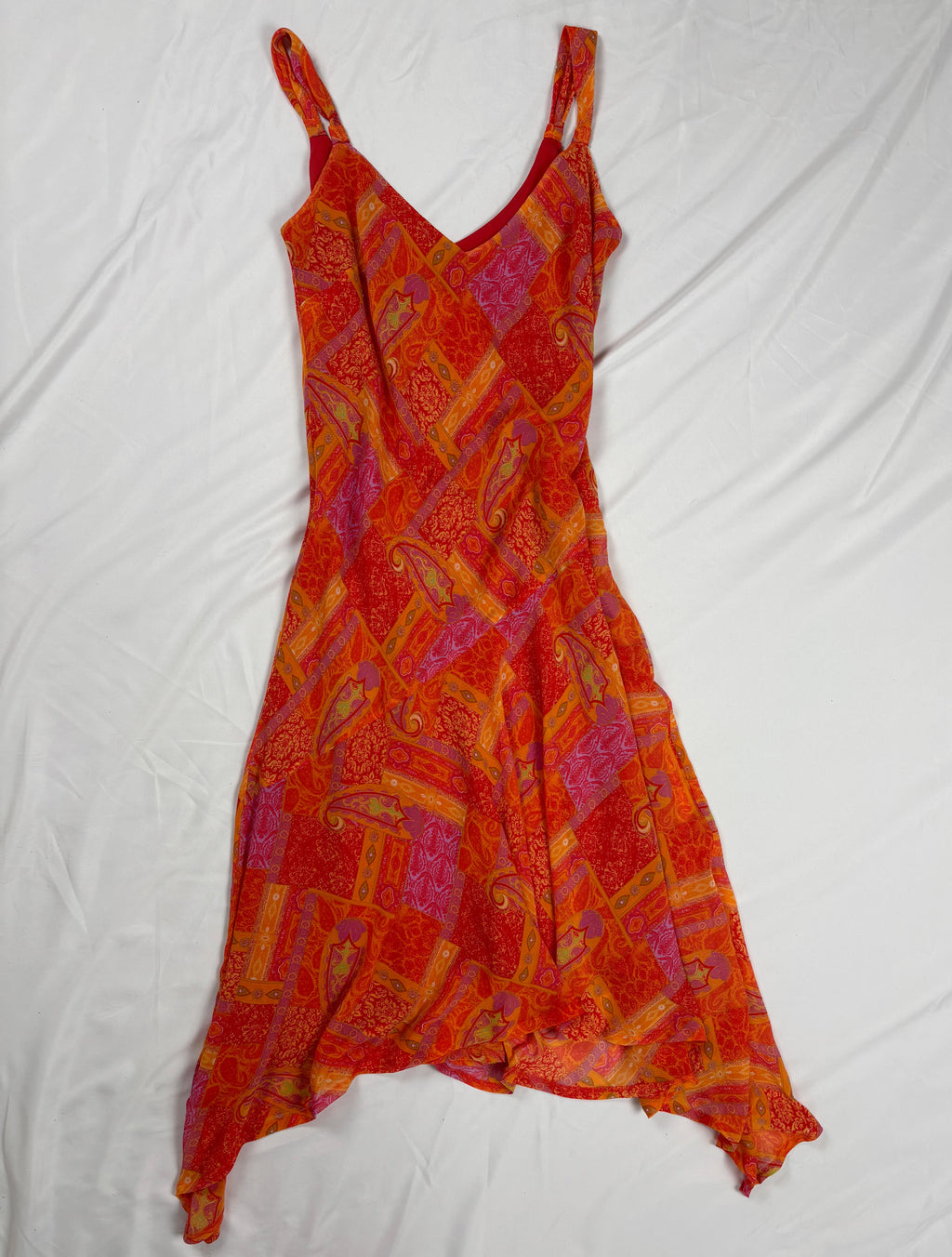 Orange paisley patchwork style midi dress with asymmetric hem