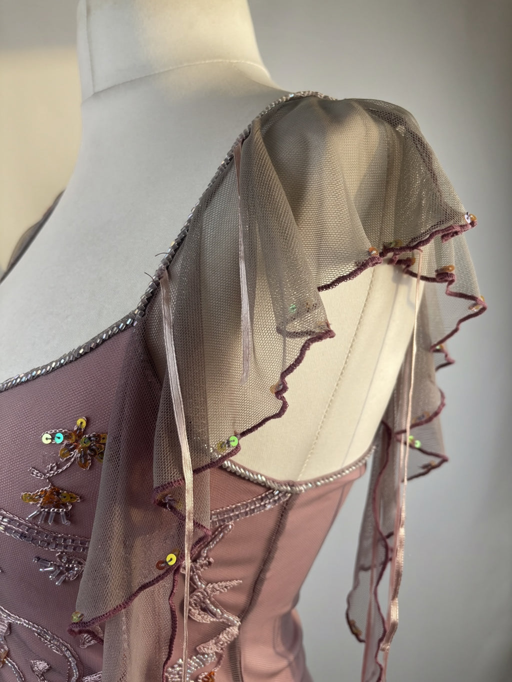 Muted purple ruffle sleeve top with embroidered sequin details