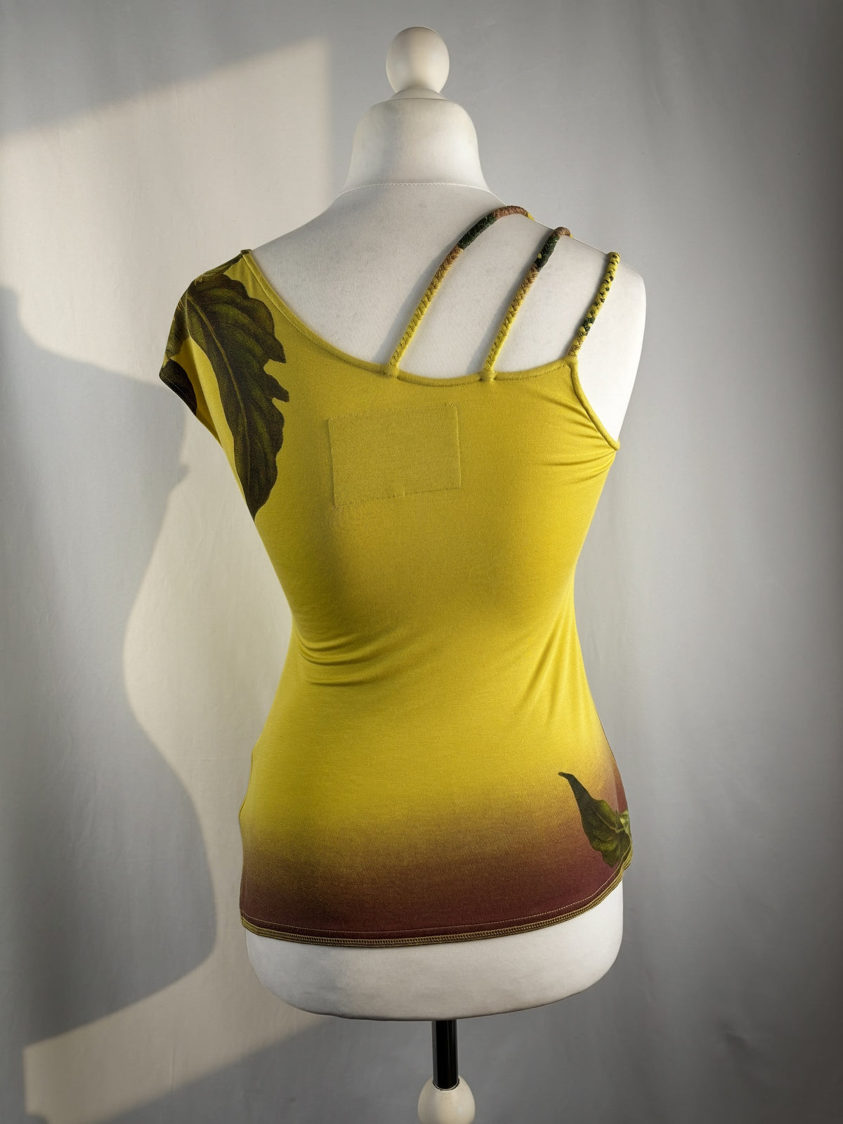 Green asymmetrical tropical print embellished top with shoulder strap detail