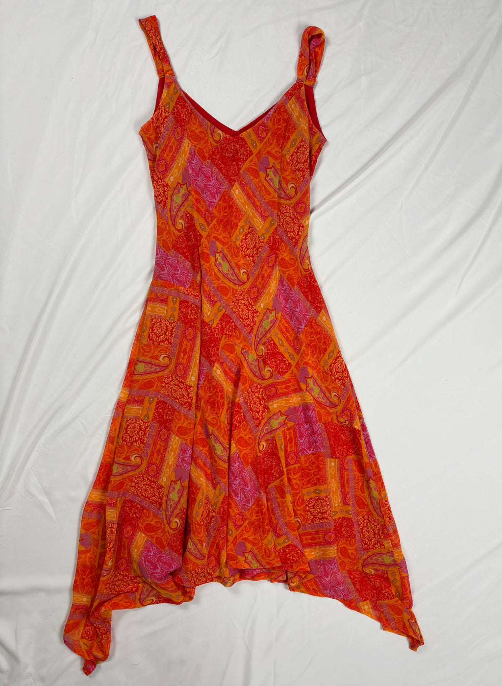 Orange paisley patchwork style midi dress with asymmetric hem