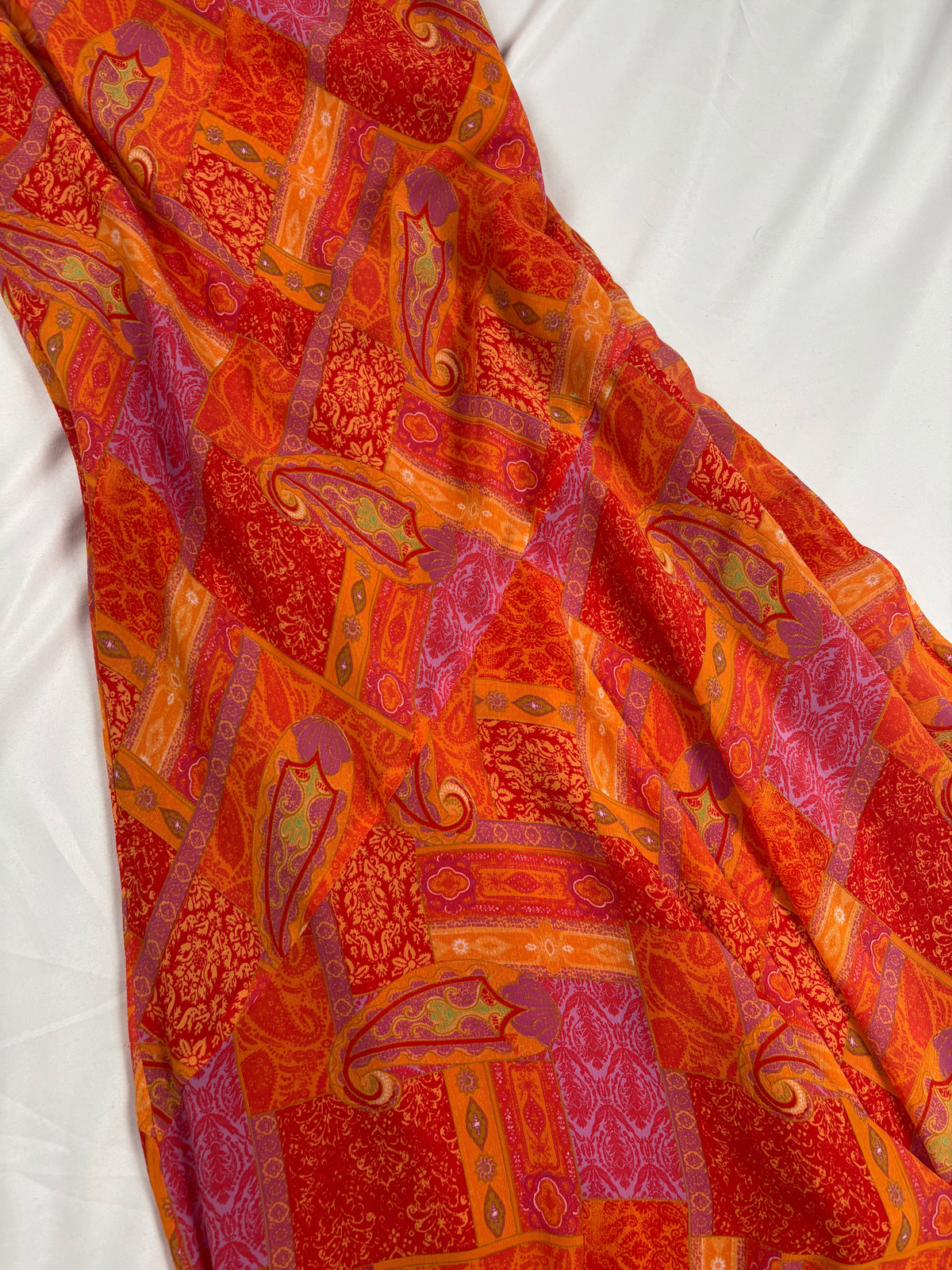 Orange paisley patchwork style midi dress with asymmetric hem
