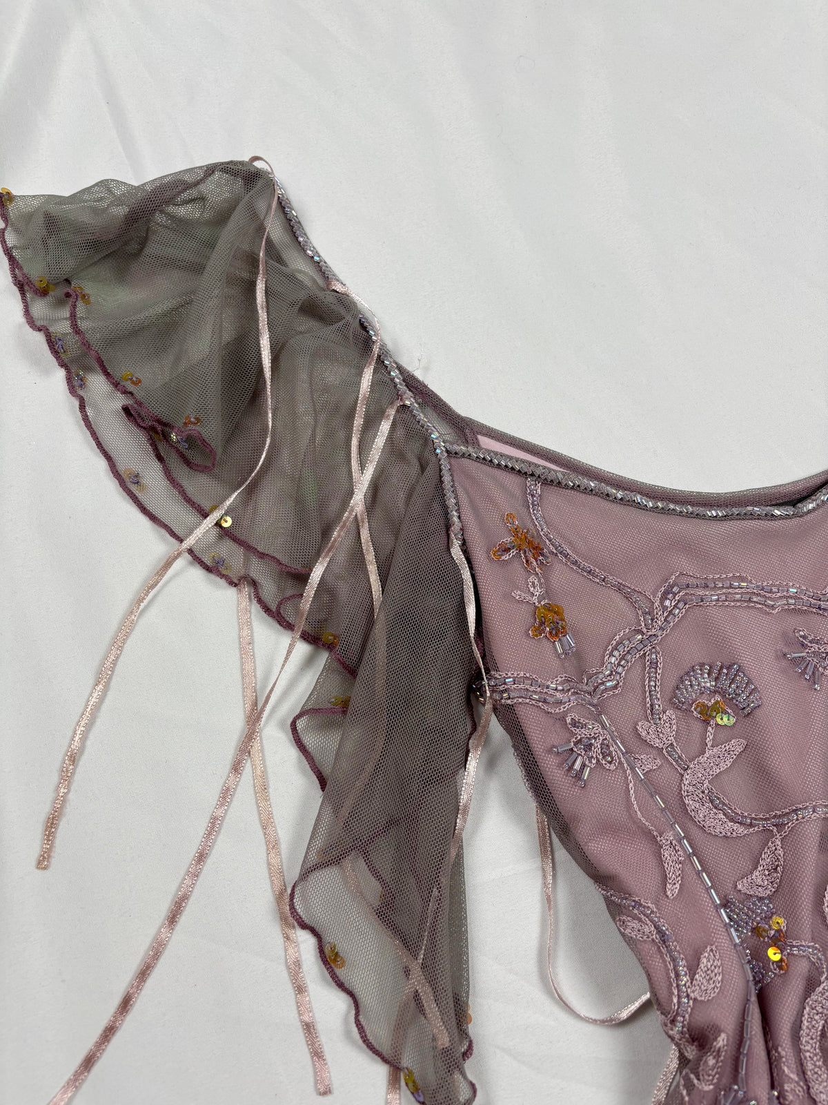 Muted purple ruffle sleeve top with embroidered sequin details