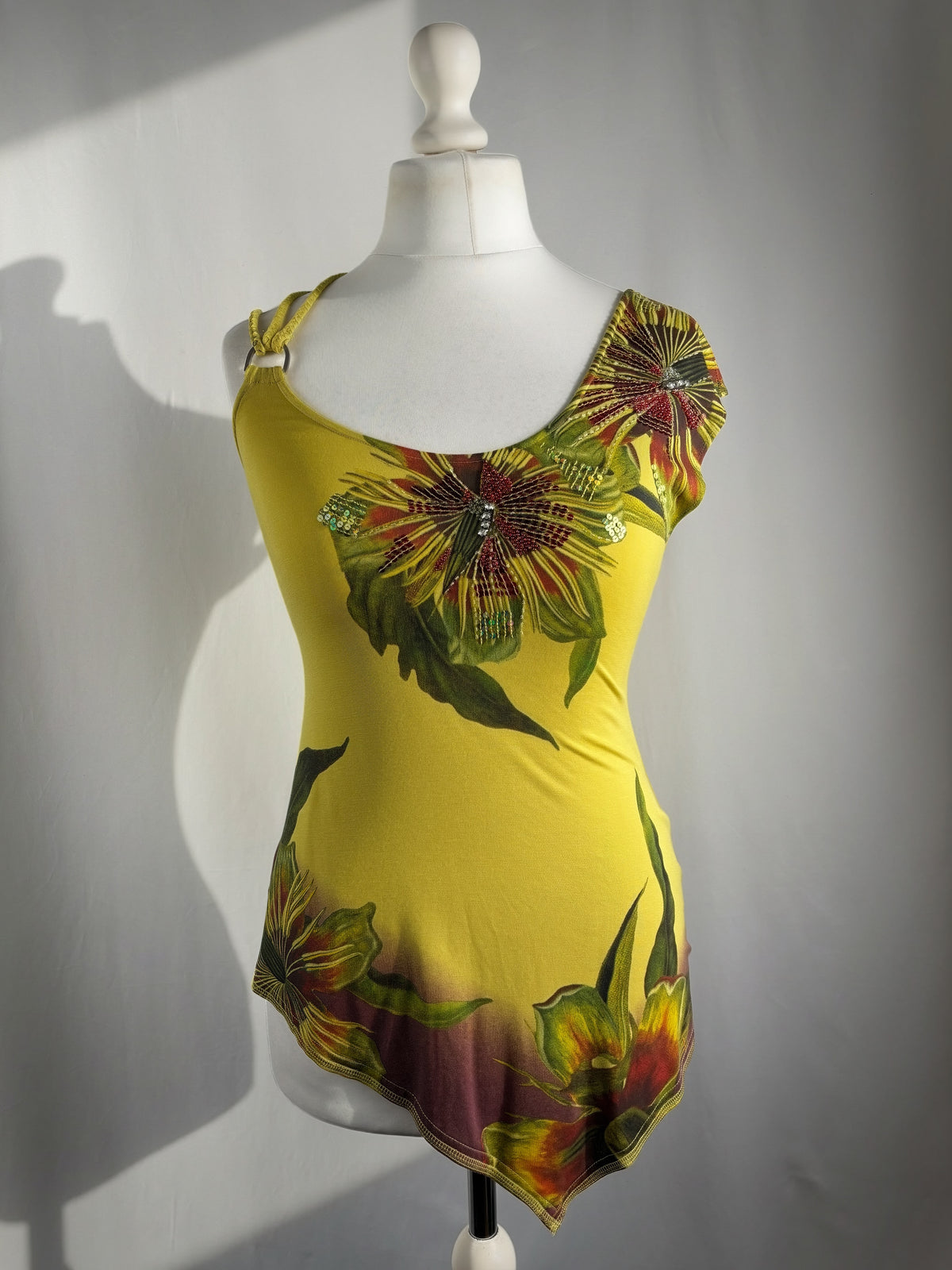 Green asymmetrical tropical print embellished top with shoulder strap detail