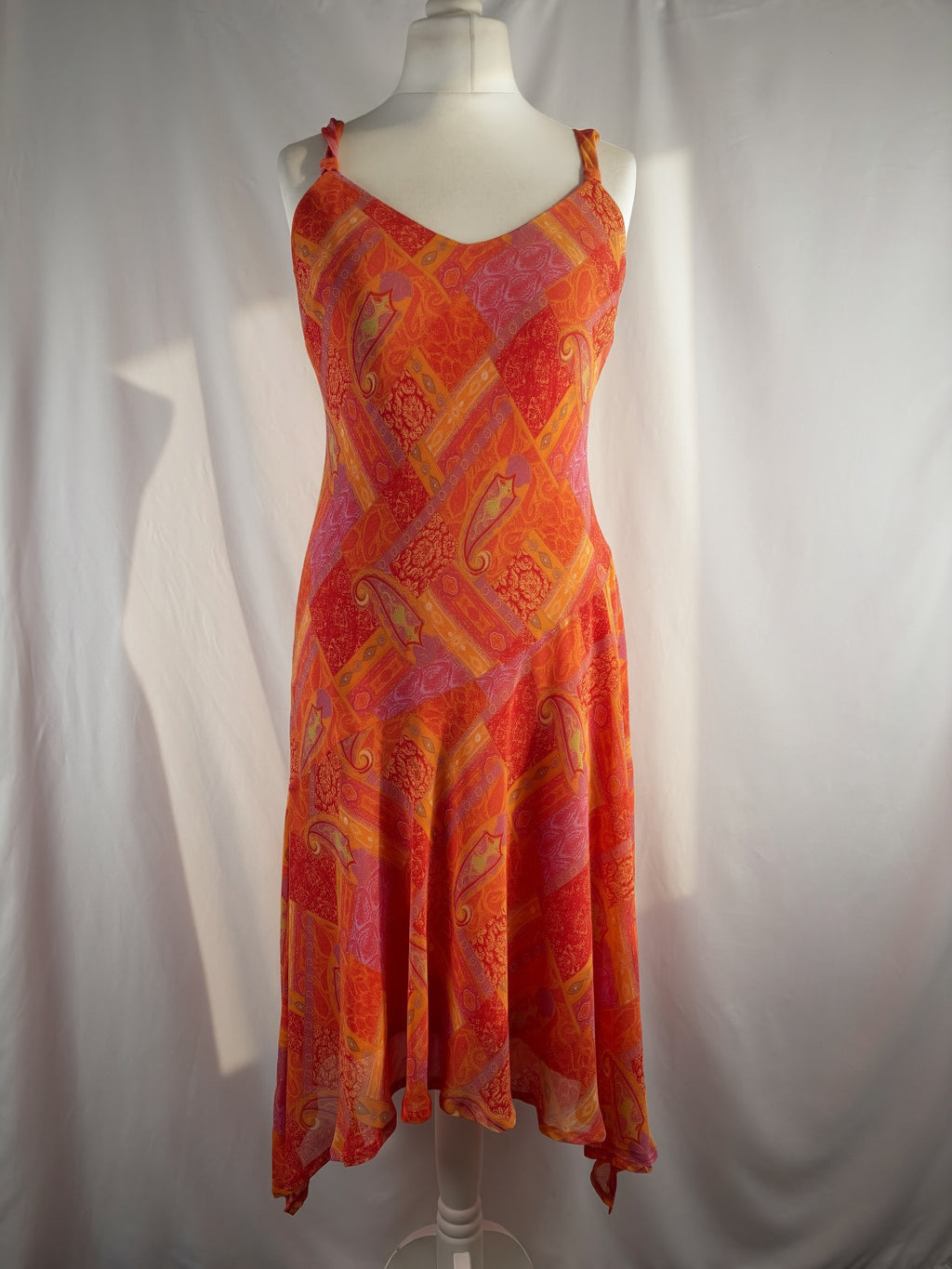 Orange paisley patchwork style midi dress with asymmetric hem
