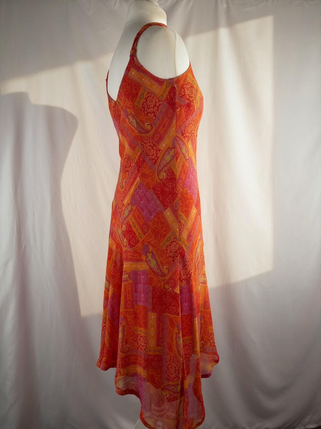 Orange paisley patchwork style midi dress with asymmetric hem