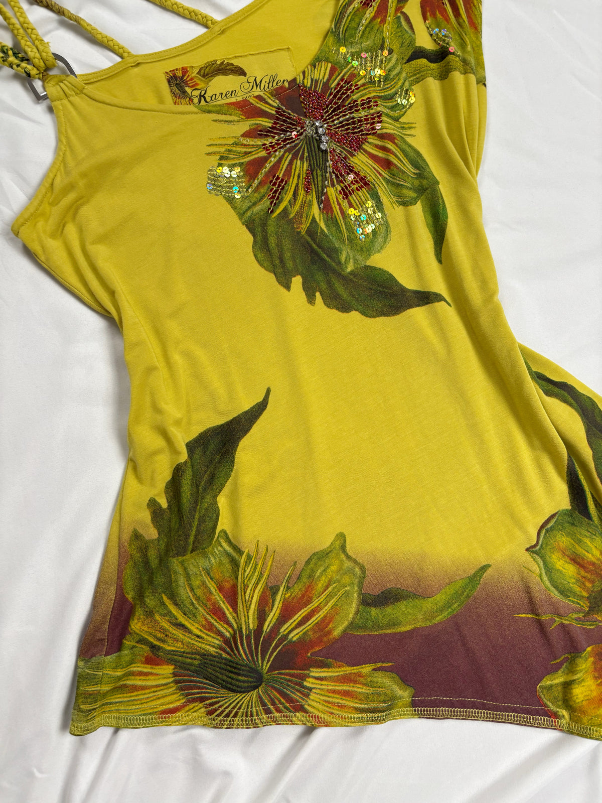 Green asymmetrical tropical print embellished top with shoulder strap detail
