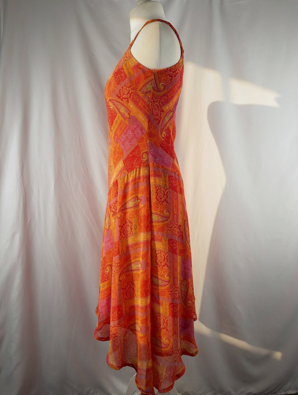 Orange paisley patchwork style midi dress with asymmetric hem