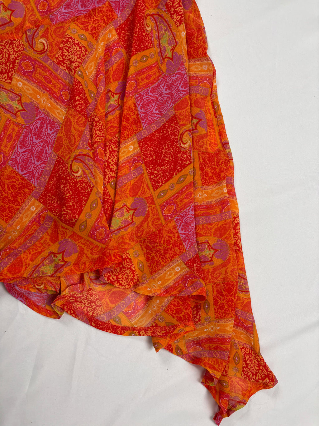Orange paisley patchwork style midi dress with asymmetric hem