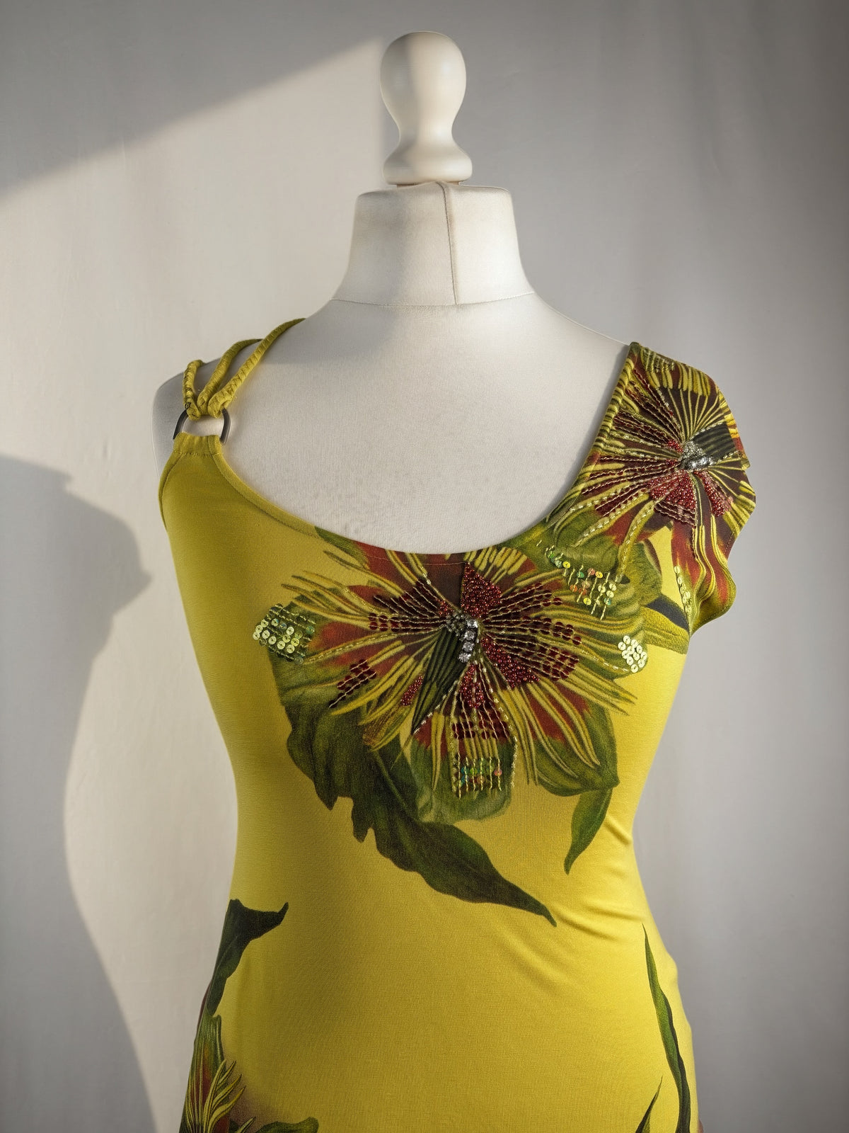 Green asymmetrical tropical print embellished top with shoulder strap detail