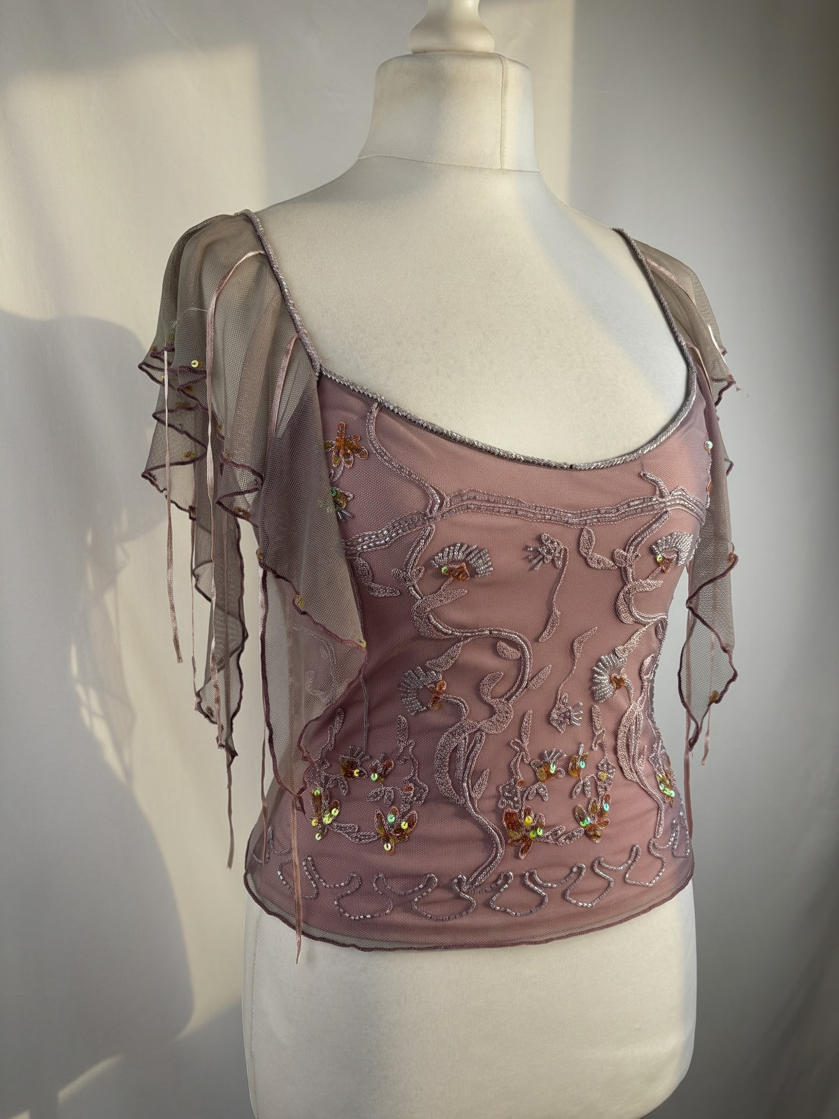 Muted purple ruffle sleeve top with embroidered sequin details