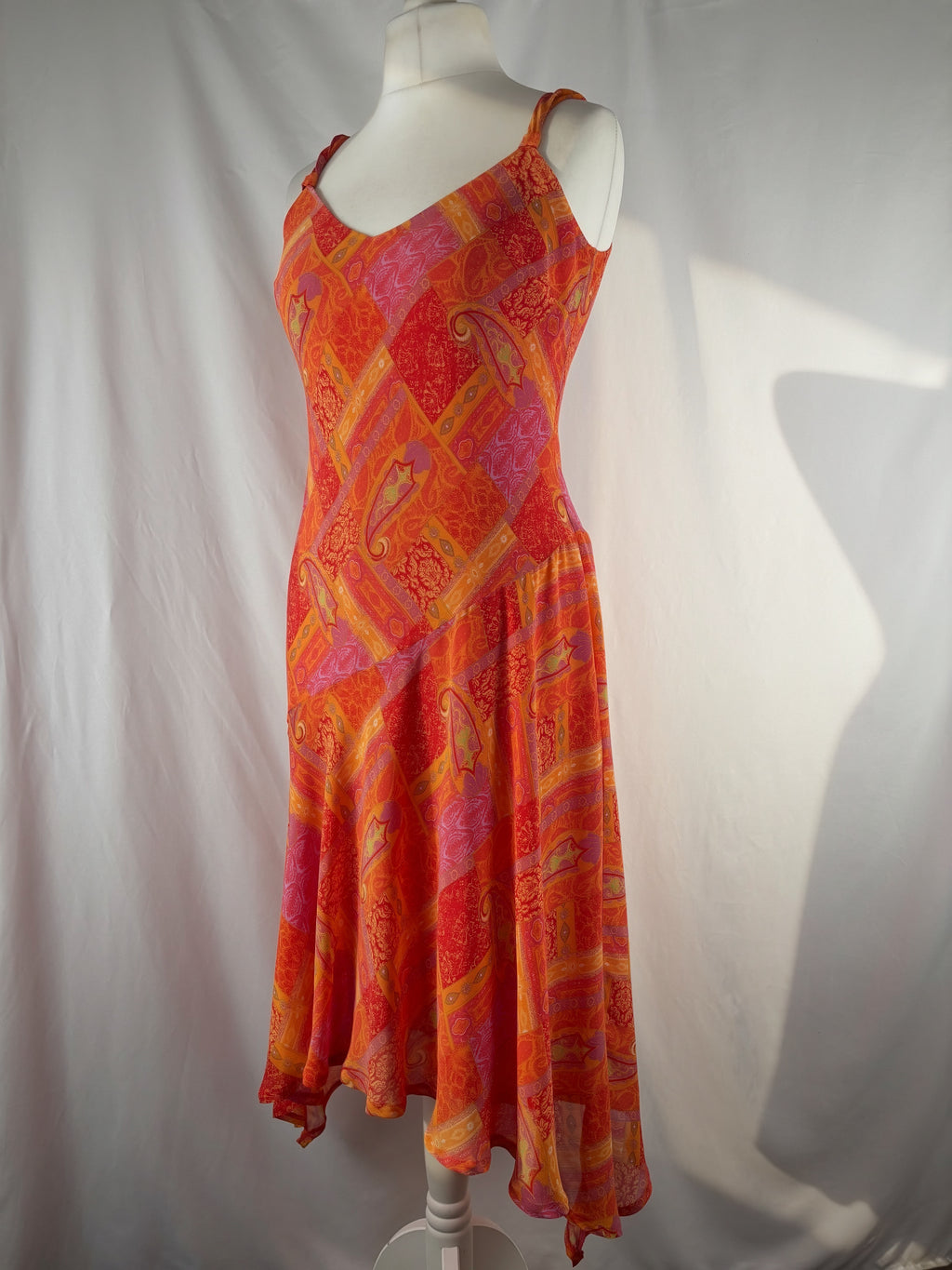Orange paisley patchwork style midi dress with asymmetric hem